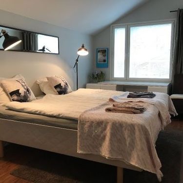 Stylish bedroom with wooden floor