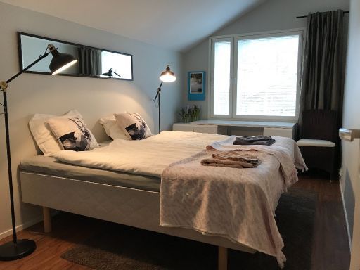 Stylish bedroom with wooden floor